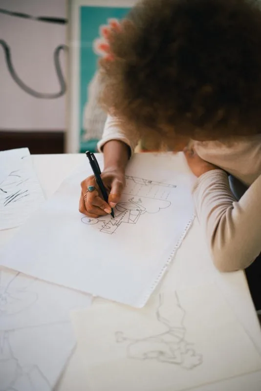 image of person drawing on paper - courtesy of Retha Ferguson